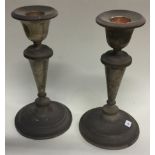 A pair of circular silver candlesticks with reeded decoration.