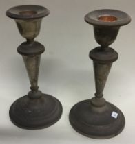 A pair of circular silver candlesticks with reeded decoration.