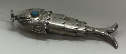 An articulated silver fish with blue stone decoration.