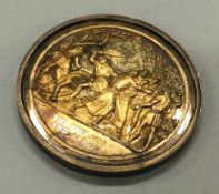 A silver gilt medallion.