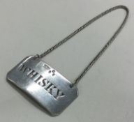 A large silver wine label for 'Whisky'. Marked to front. London 1894. By Josiah Williams & Co.