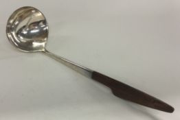 A fine Danish silver ladle with wooden handle. Marked to base.