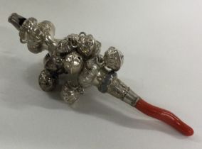 A George III silver rattle with coral teether. Circa 1800.