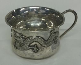 WING NAM: A silver mug chased with dragons. Circa 1900.