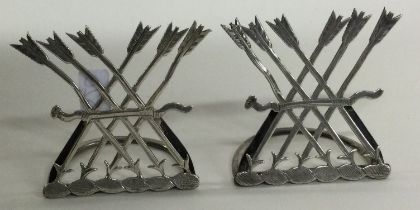 A pair of silver menu holders.