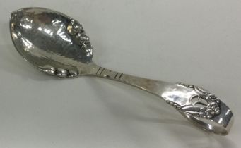 A Danish silver caddy spoon with hammered decoration.