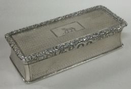 A good Victorian silver crested snuff box with engine turned decoration. Birmingham 1835.
