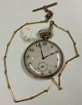 A slim gold plated pocket watch on matching chain.