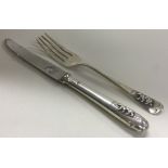 A silver christening knife and fork embossed with bears. Sheffield 1967. By Elkington & Co.