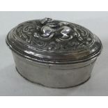 A chased Turkish silver box with lift-off lid decorated with dragons.