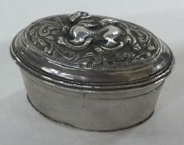 A chased Turkish silver box with lift-off lid decorated with dragons.