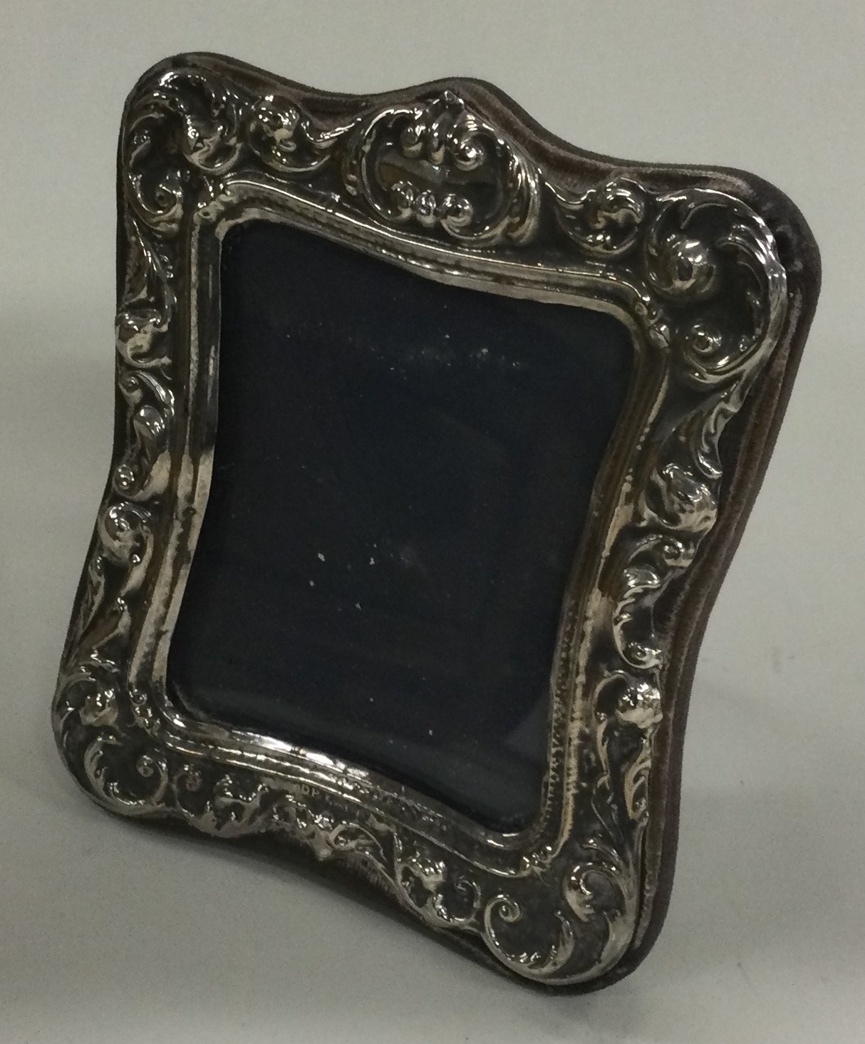 A chased silver picture frame.