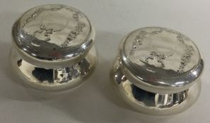A pair of silver pill boxes with swag decoration.