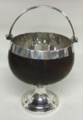 A silver swing handled coconut cup.