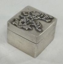 A Chinese silver stamp case with embossed decoration. By LH.