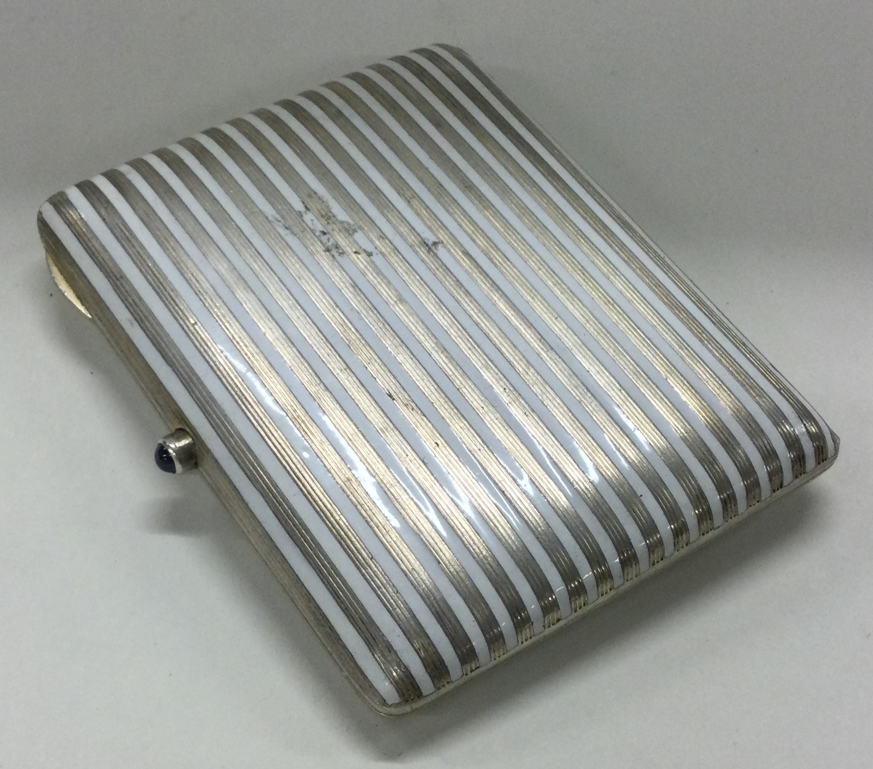 A silver and white enamelled cigarette case. Marked to interior.