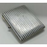 A silver and white enamelled cigarette case. Marked to interior.