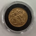A 1910 gold Full Sovereign coin.