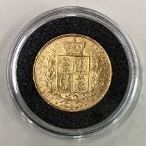 An 1864 gold shield back Full Sovereign coin.