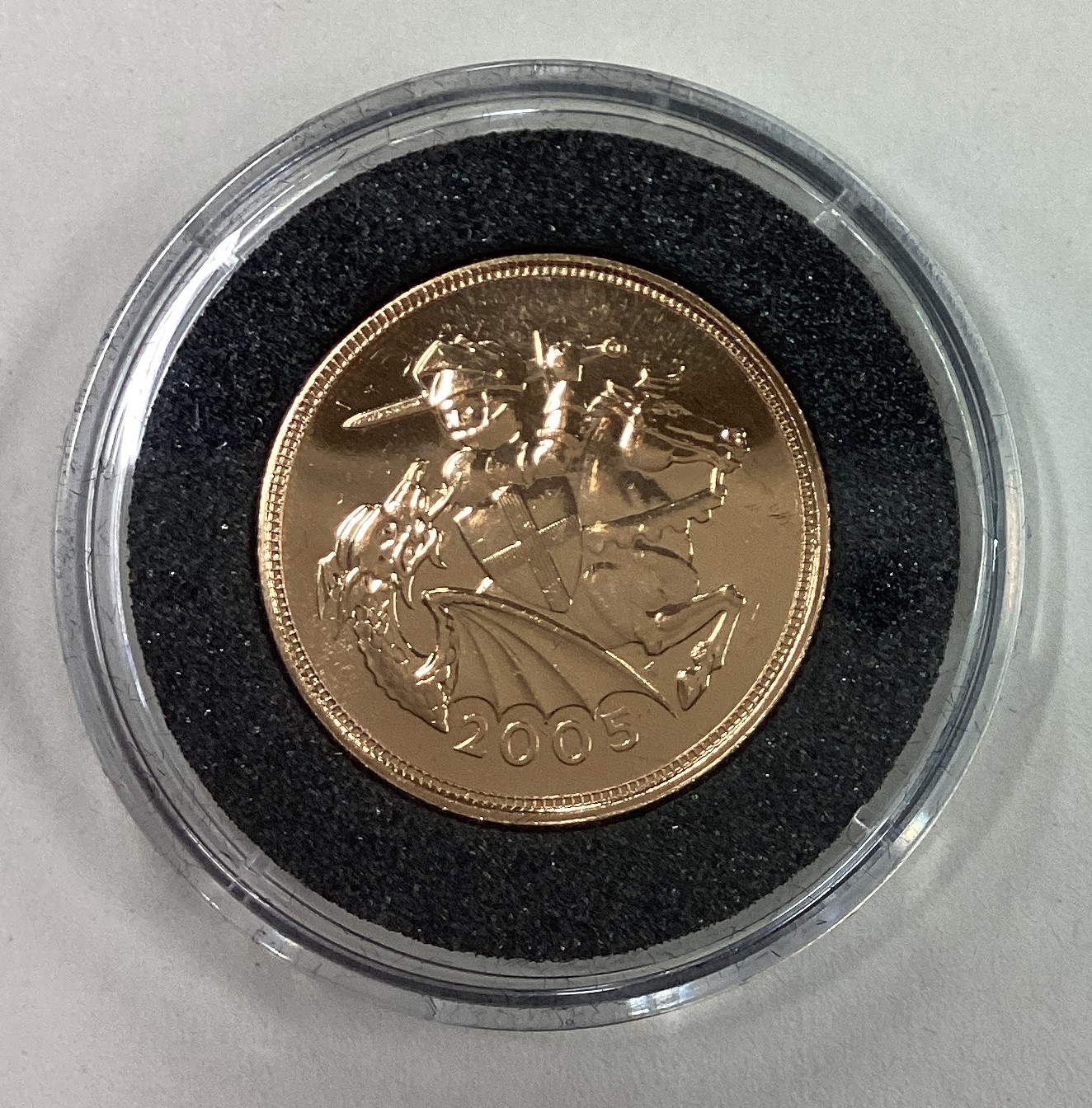 A 2005 gold Full Sovereign coin.