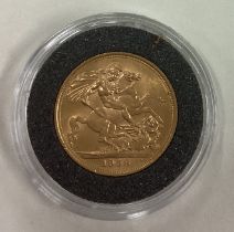 A 1958 gold Full Sovereign coin.