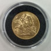 A 1928 gold Full Sovereign coin.