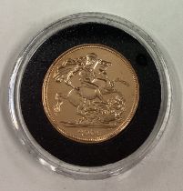 A 2006 gold Full Sovereign coin.