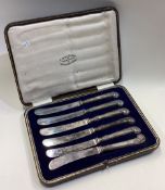 A cased set of six silver pistol handled tea knives.