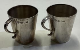 A pair of silver handled shot cups. London 1965.