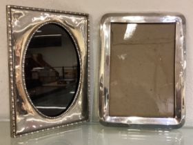 Two large modern silver picture frames.