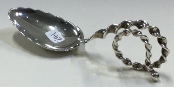 An unusual Continental silver caddy spoon with spiralled handle.