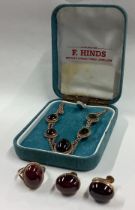 An attractive cabochon garnet necklace together with matching ring and earrings.