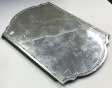 A large silver desk blotter with swag decoration.