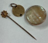 A small gold coin together with a stick pin etc.