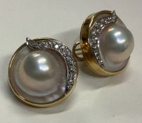 A large pair of diamond and pearl earrings in 18 carat gold setting.