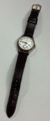LONGINES: A gent's 9 carat wristwatch with leather strap.