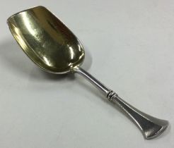A Russian silver caddy spoon.