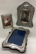 A collection of three silver mounted picture frames.