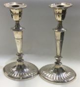 A large pair of silver candlesticks.