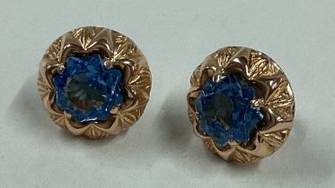 A pair of blue stone earrings in 18 carat gold claw setting.