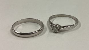 A small diamond single stone ring together with matching band in 18 carat white gold setting.