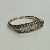 A good diamond five stone ring in 18 carat gold carved mount.