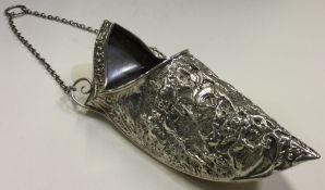CHESTER: A large chased silver shoe with embossed decoration.