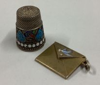 An attractive silver gilt envelope together with a Russian silver thimble.