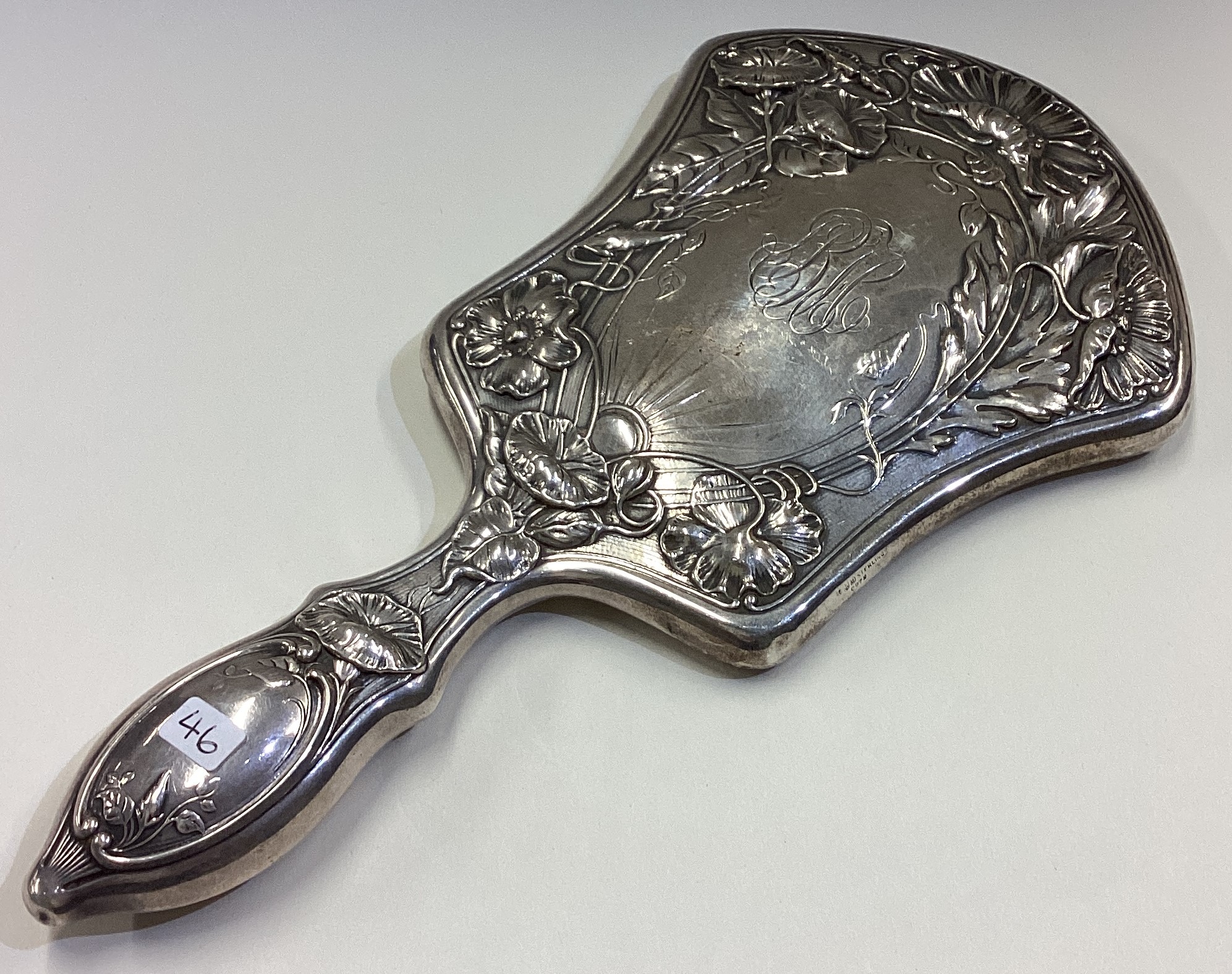 A fine and heavy Gorham silver mirror heavily chased with flowers.