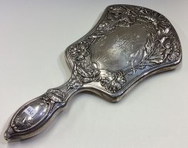 A fine and heavy Gorham silver mirror heavily chased with flowers.