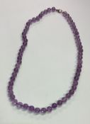 An amethyst necklace with ring clasp.