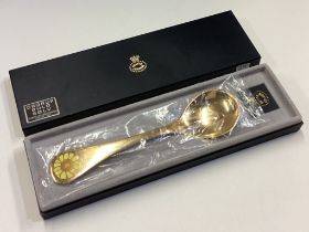 GEORG JENSEN: A cased silver gilt spoon.