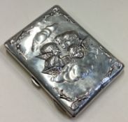 A chased silver card case embossed with cherubs.