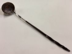 A 19th Century silver and whalebone ladle with gold coin to centre.